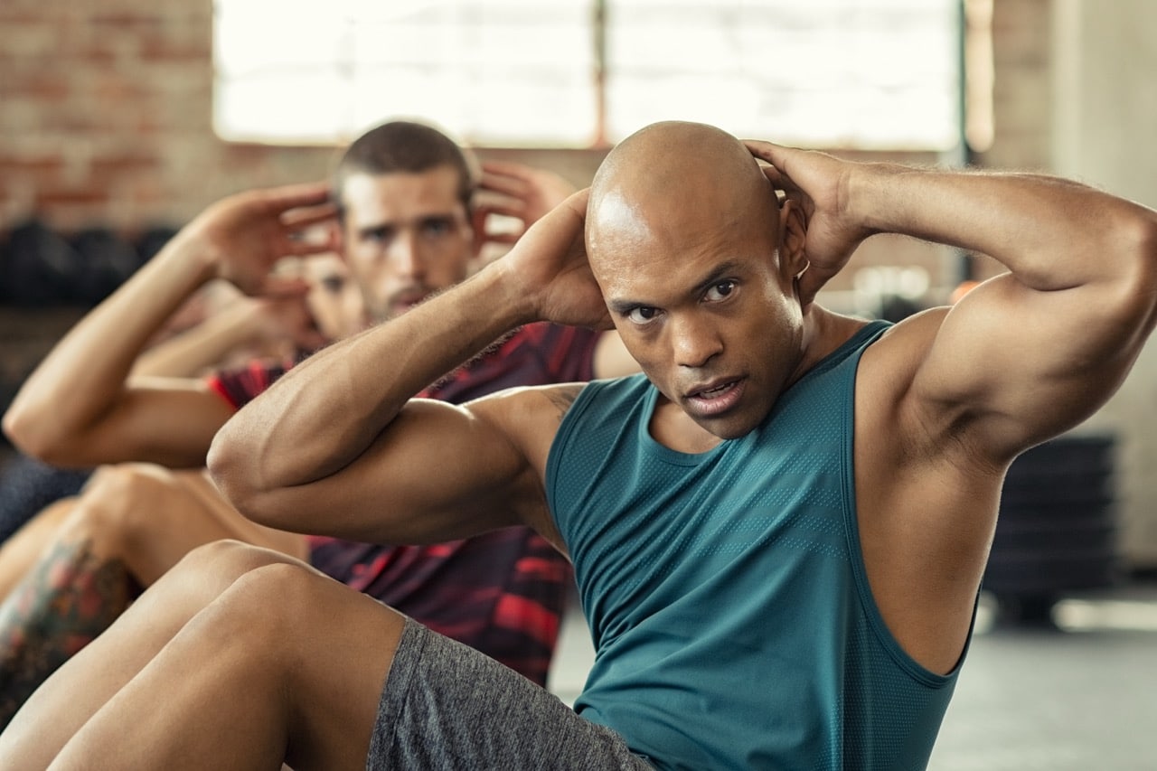 Muscular guy doing crunches.